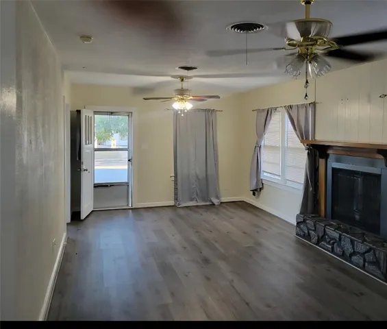 wooden floor in an empty room with a fireplace