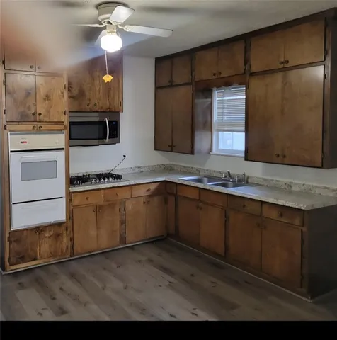 a kitchen with a sink stainless steel appliances and cabinets