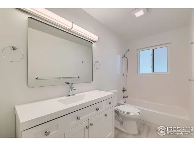 a bathroom with a sink a toilet a mirror and vanity
