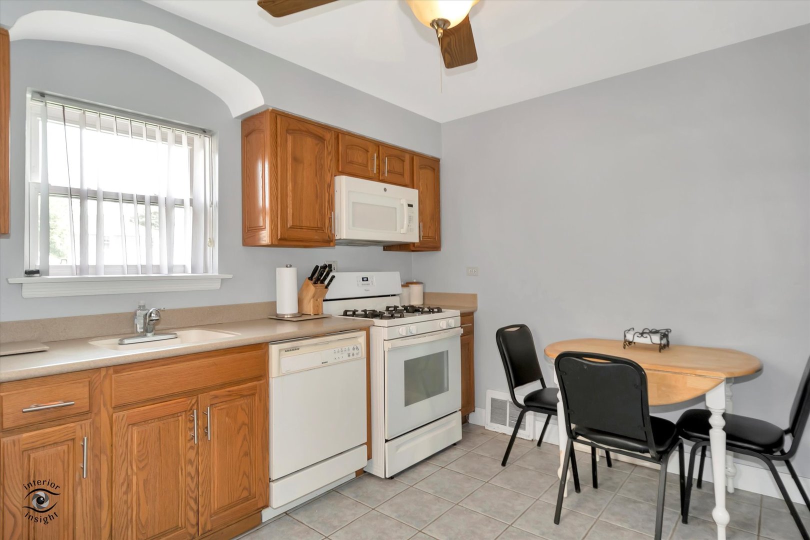 2546 West 110th Street Chicago, IL 60655 - Photo 11 of 26 a view of a kitchen counter space a sink and chairs