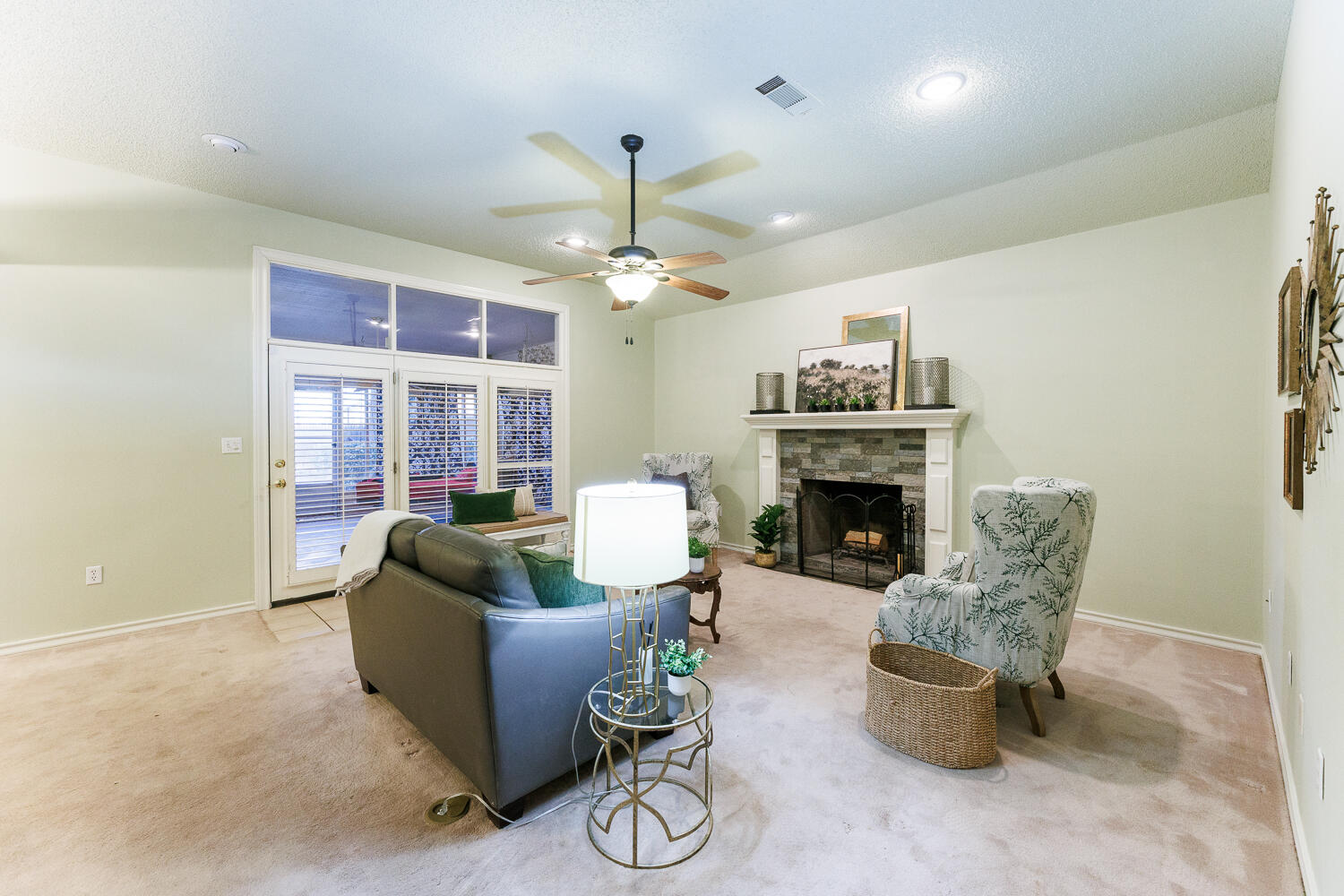 206 Collins Avenue Sundown, TX 79372 - Photo 7 of 82 a living room with furniture a fireplace and a chandelier