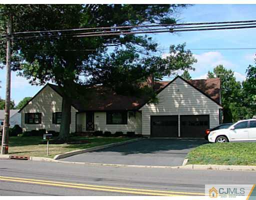 422 Ridge Road Dayton, NJ 08810 - Photo 1 of 24 a front view of a house with a yard