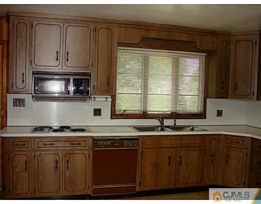 422 Ridge Road Dayton, NJ 08810 - Photo 20 of 24 a kitchen with stainless steel appliances granite countertop a stove a sink and a granite counter tops