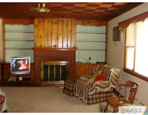 422 Ridge Road Dayton, NJ 08810 - Photo 3 of 24 a bedroom with a bed and a fireplace