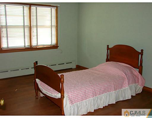 422 Ridge Road Dayton, NJ 08810 - Photo 5 of 24 a bedroom with a bed and a window