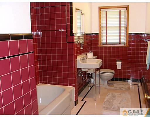422 Ridge Road Dayton, NJ 08810 - Photo 6 of 24 a bathroom with a sink a toilet and shower