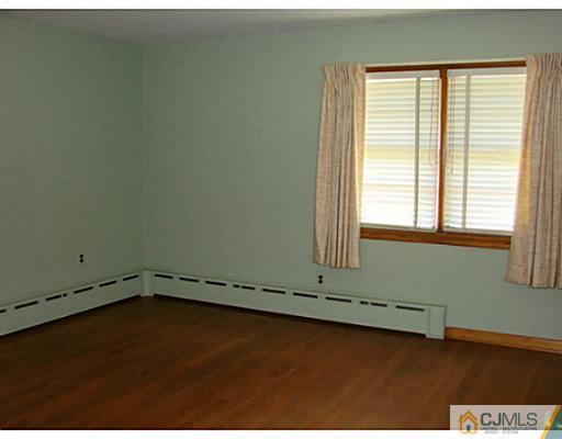 422 Ridge Road Dayton, NJ 08810 - Photo 7 of 24 an empty room with a window