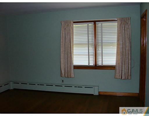 422 Ridge Road Dayton, NJ 08810 - Photo 8 of 24 a view of an empty room with a window