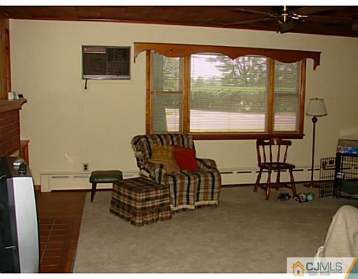 422 Ridge Road Dayton, NJ 08810 - Photo 9 of 24 a living room with furniture and a floor to ceiling window