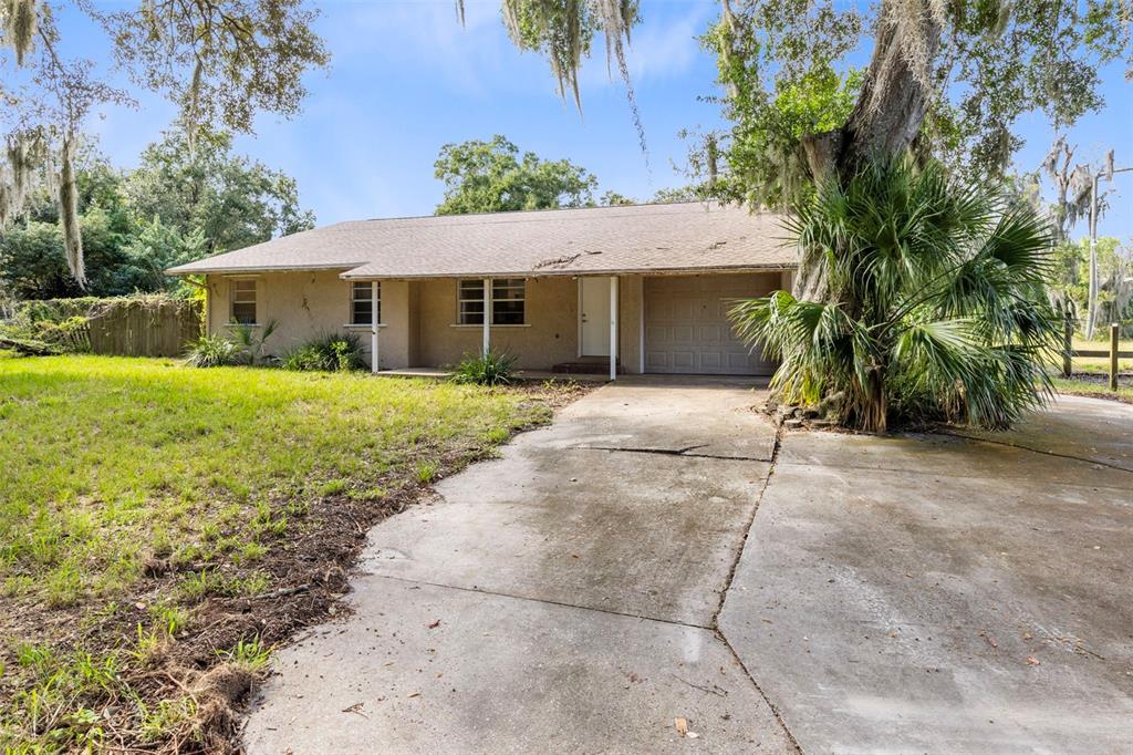 4040 Mullens Road Mims, FL 32754 - Photo 1 of 1 a front view of a house with garden