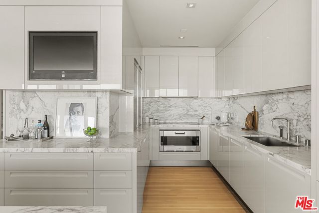 a kitchen with granite countertop a sink and cabinets