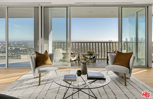 a living room with furniture and a floor to ceiling window