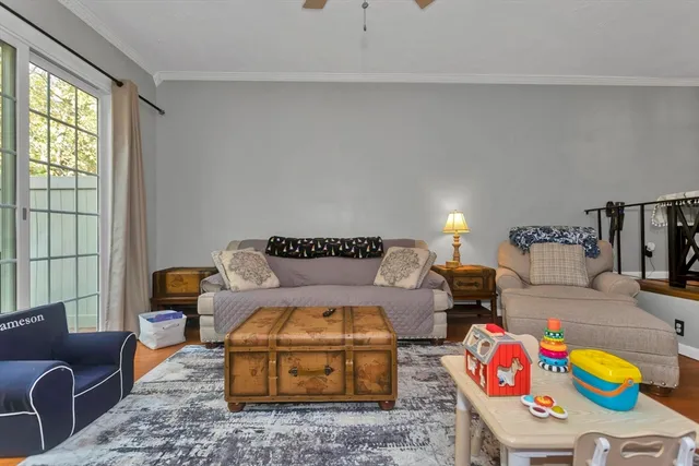 a living room with furniture fireplace and window