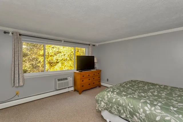 a bedroom with bed and window