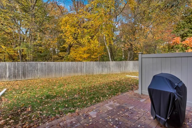a view of garden with wooden fence