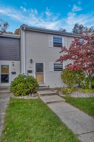 a front view of a house with a garden