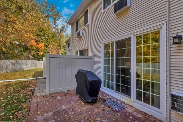 a view of a chair and table in the backyard