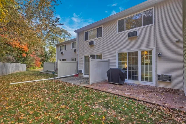 a view of a backyard with table and chairs and a barbeque