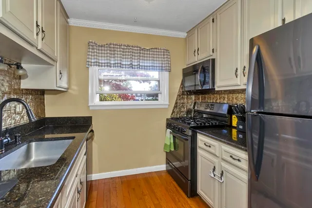a kitchen with wooden cabinets and a stove top oven