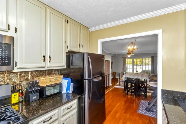 a kitchen with refrigerator and cabinets