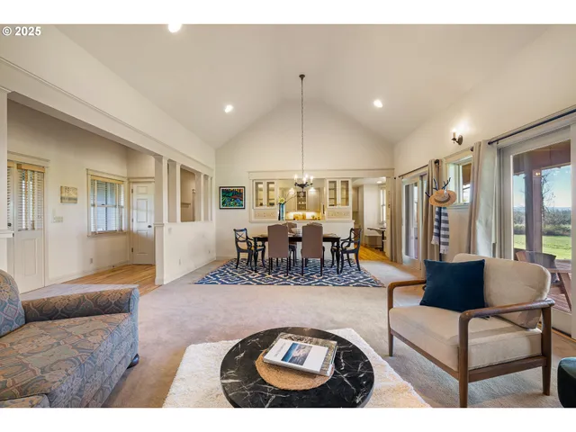 a living room with furniture a wooden floor and chandelier