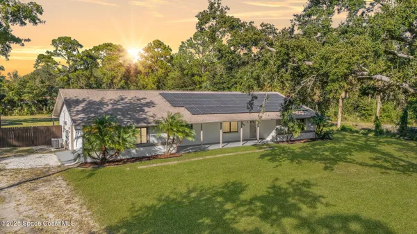 an aerial view of a house with a garden