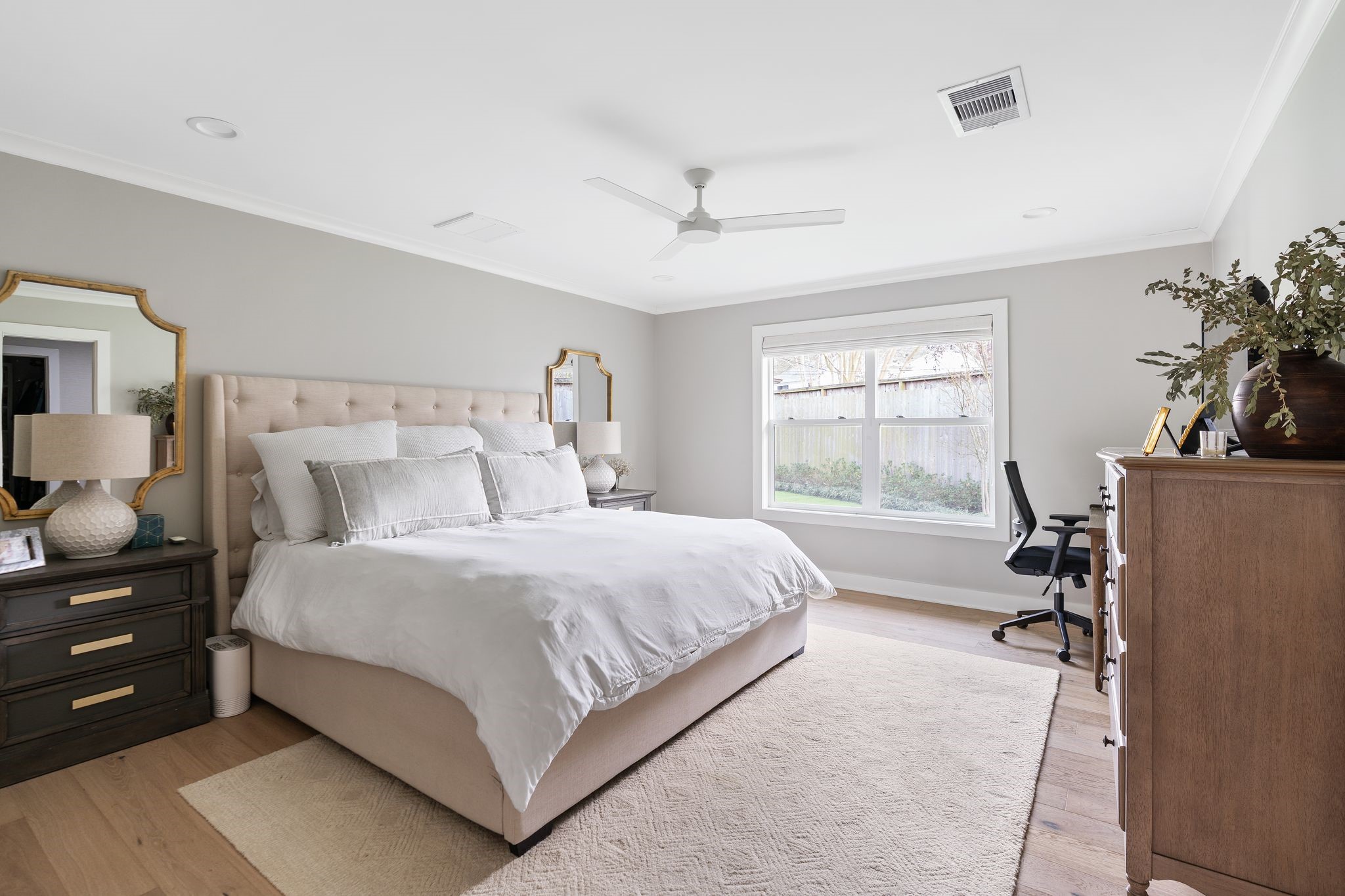 4902 Candleleaf Drive Houston, TX 77018 - Photo 17 of 32 The primary bedroom feels like a calm retreat, layered with Schumacher wallpaper and soft natural light, with windows that look out to the backyard.