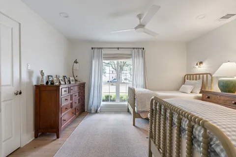 a bedroom with furniture and wooden floor