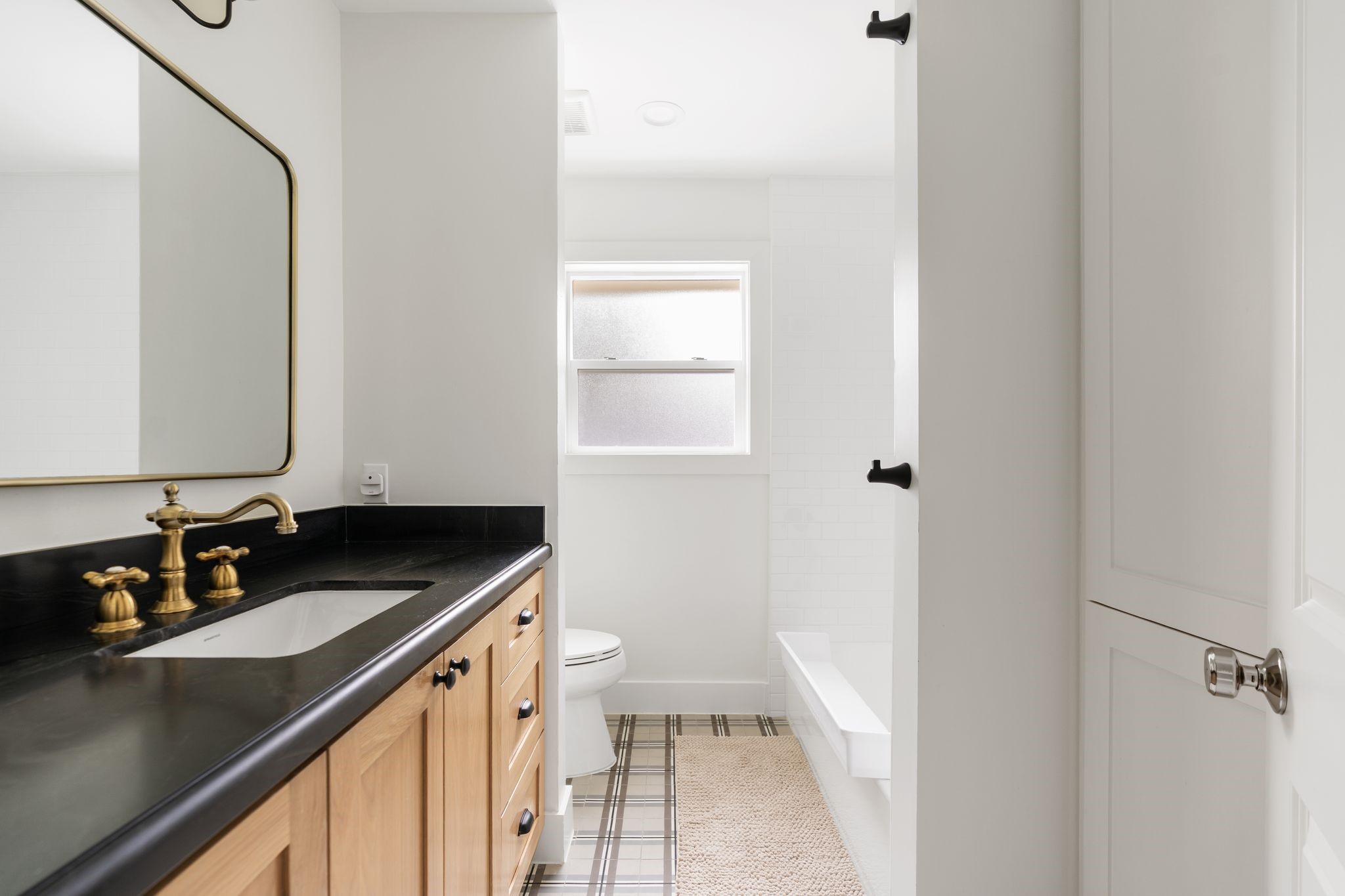 4902 Candleleaf Drive Houston, TX 77018 - Photo 23 of 32 Patterned tile floors add personality, while furniture-style cabinetry keeps the space feeling classic and tailored in this shared bathroom.