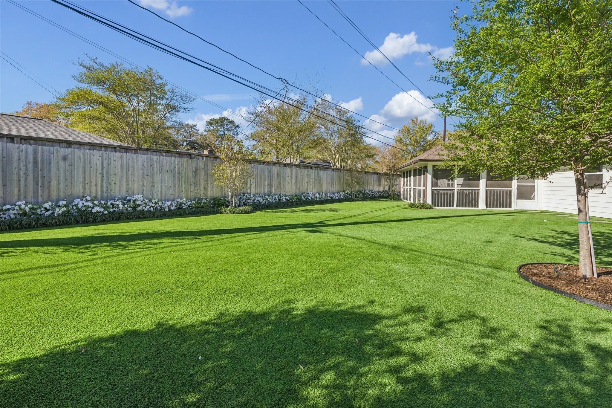 4902 Candleleaf Drive Houston, TX 77018 - Photo 29 of 32 The backyard has been thoughtfully reimagined with turf and privacy fencing for low-maintenance enjoyment.
