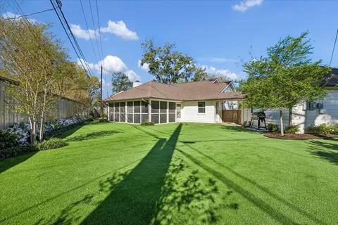 a view of a house with a big yard and potted plants