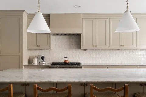 a kitchen with a sink cabinets and window