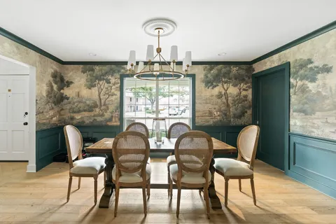 a dining room with furniture and window