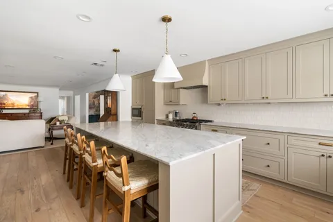 a kitchen with sink cabinets and wooden floor