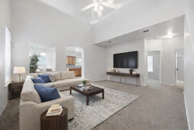 a living room with furniture and a flat screen tv