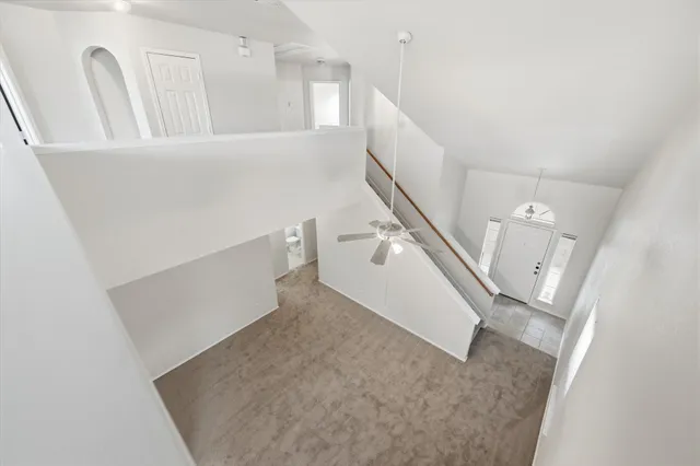 a view of a kitchen with furniture and stairs