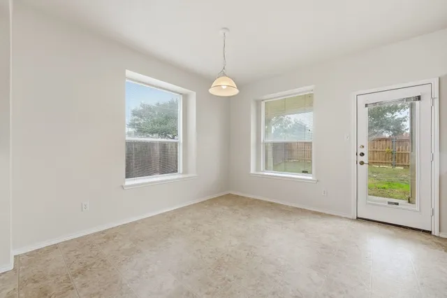 a view of an empty room with windows