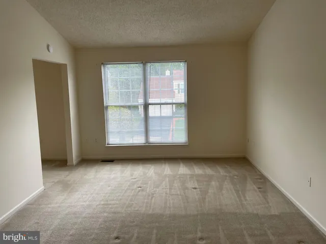 an empty room with a empty space and window