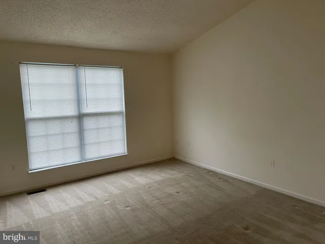 an empty room with a empty space and window