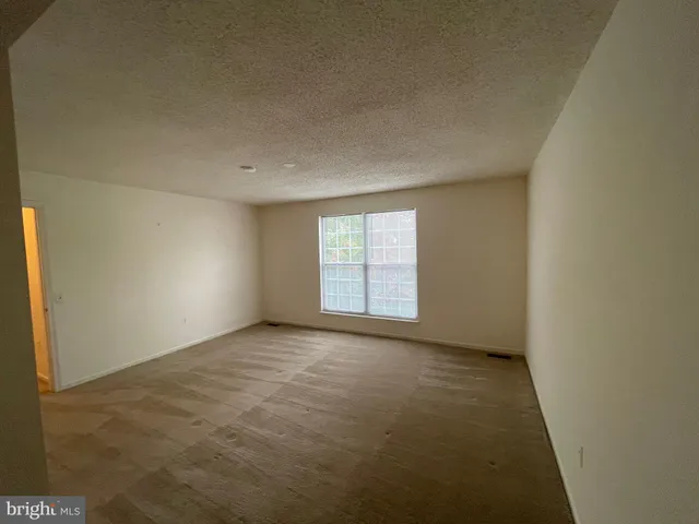 a view of an empty room with glass door