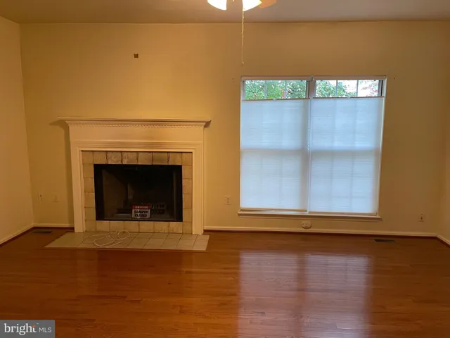 a view of a fireplace in an empty room with a fireplace