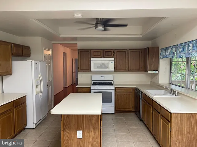 a kitchen with a sink stove and refrigerator