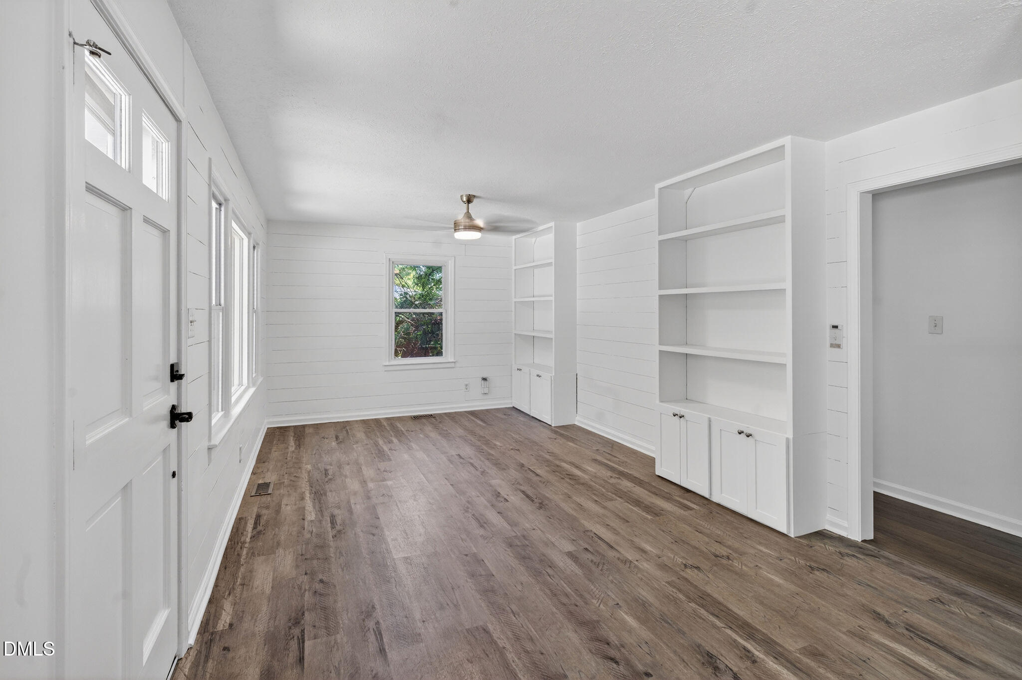 904 Seabrook Road Raleigh, NC 27610 - Photo 2 of 31 a view of empty room with wooden floor and fan