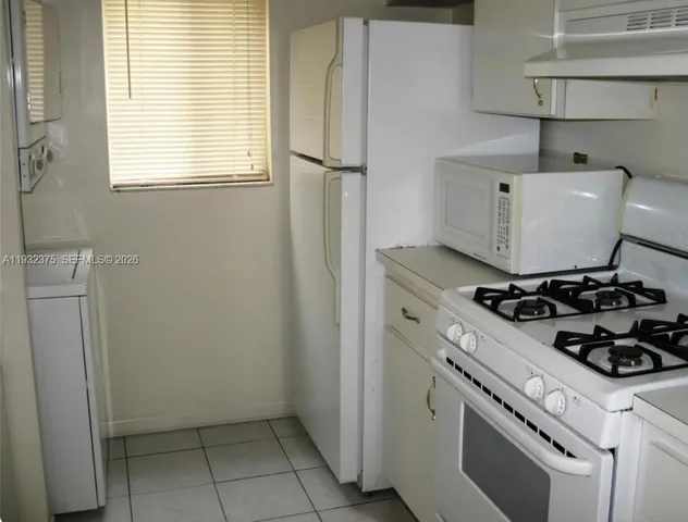 a kitchen with a stove and a refrigerator