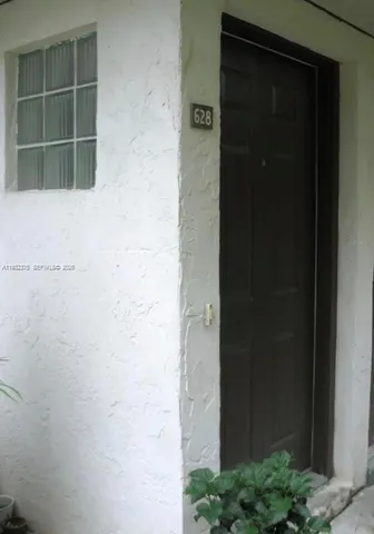 a view of a back yard with potted plants