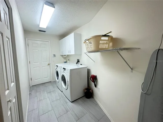 a view of a tree in front of a house with a yard