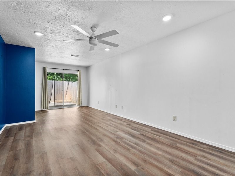 6631 Ambler Drive Spring, TX 77379 - Photo 20 of 37 an empty room with wooden floor fan and windows