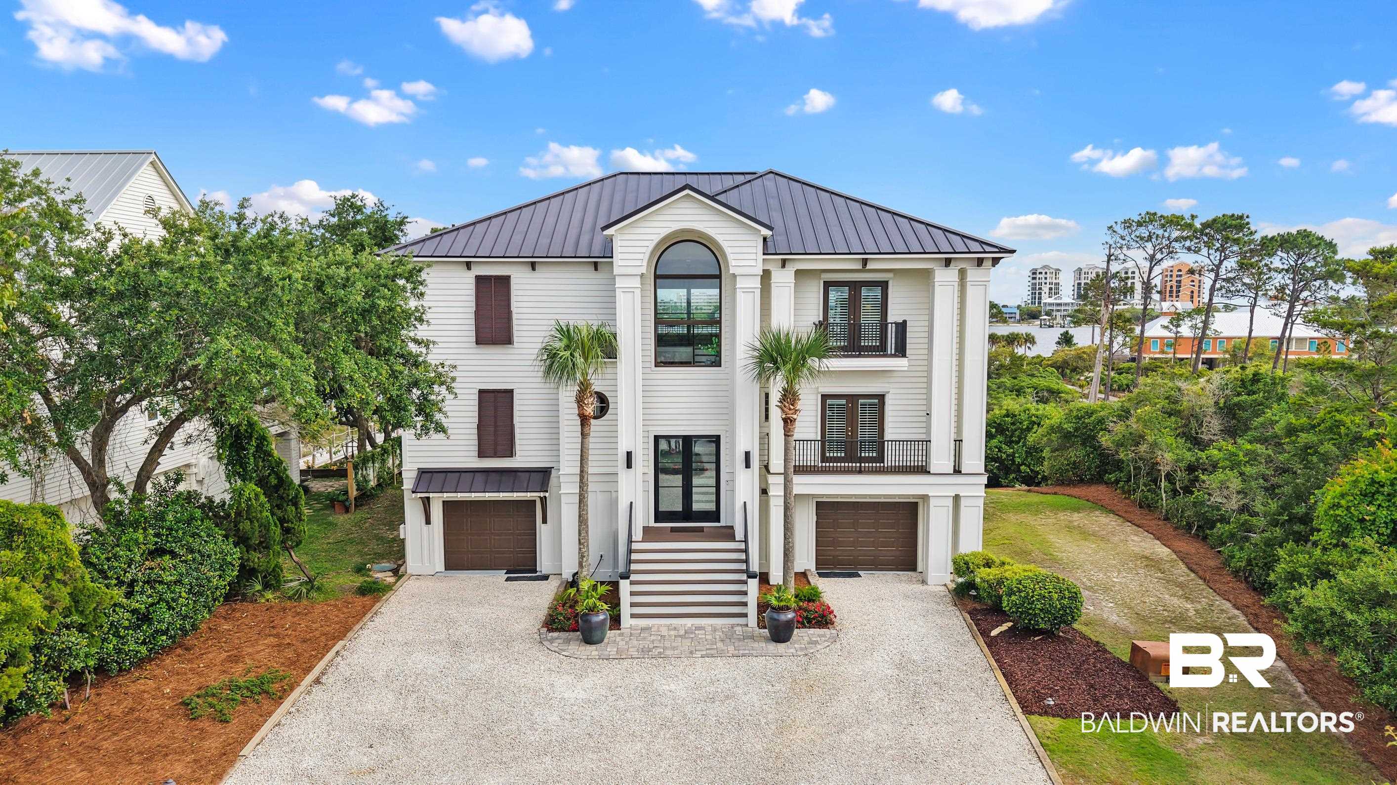 30954 River Road Orange Beach, AL 36561 - Photo 7 of 59 View of front of property featuring french doors, a garage, asphalt driveway, and stairway