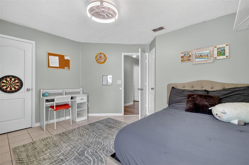 14520 Lost Lake Road Clermont, FL 34711 - Photo 43 of 54 a bedroom with a bed and a table in it