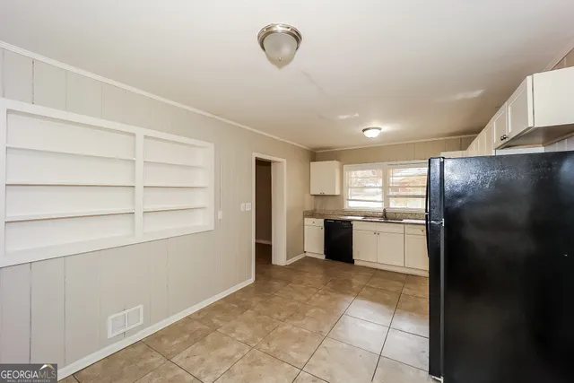 a large kitchen with a stove a refrigerator and a sink